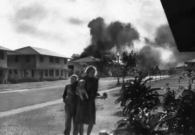 Officers' wives, investigating explosions and seeing smoke in the distance, heard neighbor Mary Naiden, then an Army hostess who took this picture, exclaim [There are red circles on those planes overhead. They are Japanese!] Realizing war had come, the two women, stunned, started toward quarters. (Mary Naiden/Associated Press)
