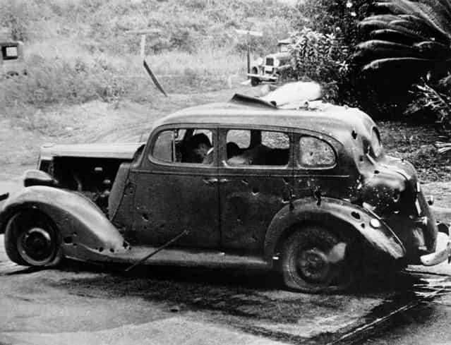 Eight miles from Pearl Harbor, shrapnel from a Japanese bomb riddled this car and killed three civilians. The Navy reported there was no nearby military objective. (U.S. Navy/Associated Press)