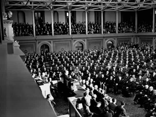 Congressmen, cabinet members, Supreme Court justices, and others listen as a grim President Franklin D. Roosevelt asks for war against Japan: [With confidence in our armed forces – with the unbounding determination of our people – we will gain the inevitable triumph - so help us, God]. President Roosevelt spoke in the House of Representatives, addressing a joint session of Congress, December 8, 1941. (Photo by Associated Press)
