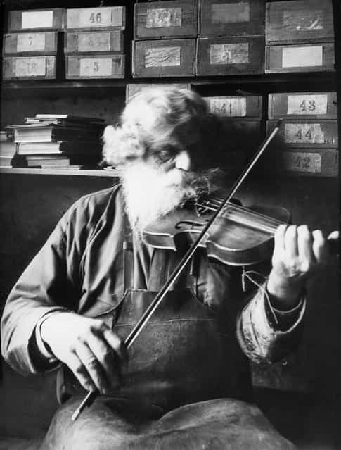 Petrus Norling, Knivsta, Uppland, Sweden, 1938. The shoemaker, woodcarver and fiddler Petrus Norling in Knivsta, playing the violin. Born in 1869. (Photo by Einar Erici)