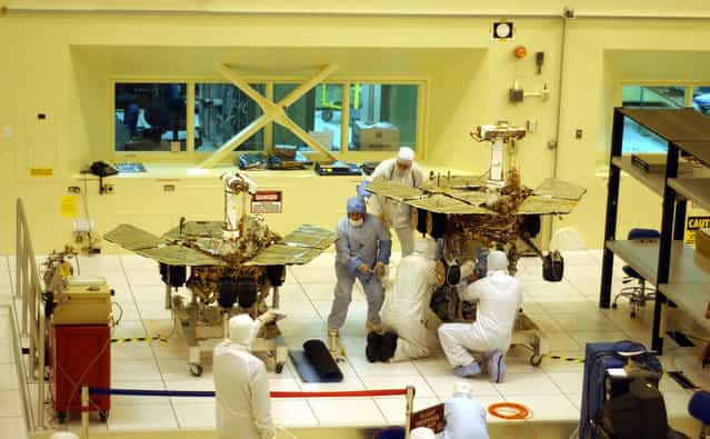 Workers put final touches to the two new Mars exploration rovers at NASA's Jet Propulsion Laboratory, on February 10, 2003 in Pasadena, California. The identical robotic explorers will search for evidence of liquid water in two separate areas of the red planet. (Photo by David McNew/The Atlantic)