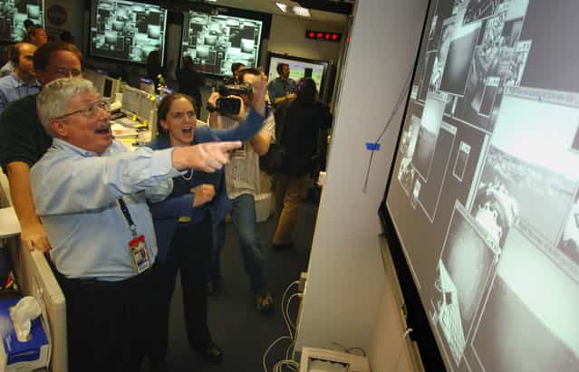 On the day of Opportunity's landing – 202 days after launch – Pete Theisinger, Project Manager, and Jennifer Trosper, Spirit Mission Manager for Surface Operations react as the first images arrive from the NASA Mars Rover Opportunity. (Photo by Bill Ingalls/AFP Photo/The Atlantic)