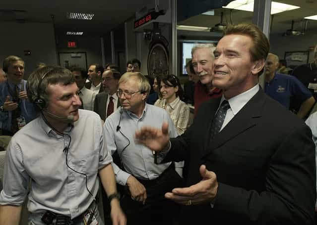 California Gov. Arnold Schwarzenegger cheers with Dr. Steve Squyres, principal investigator for Opportunity, and other Mars rovers team members in the Mission Control Center at NASA's JPL in Pasadena, California, on January 24, 2004., following the safe landing of the Opportunity rover on Mars. (Photo by Damian Dovarganes/AP Photo/Pool/The Atlantic)