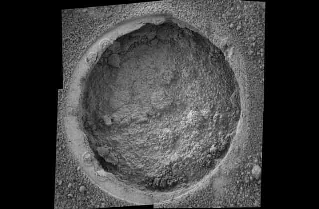 This image taken by Opportunity shows a target dubbed [Campbell] on a rock called [MacKenzie] in [Endurance Crater]. Opportunity dug a hole into the target with its rock abrasion tool, then captured this picture with its microscopic imager on sol 184 (July 30, 2004). The image mosaic is about 6 centimeters (2.4 inches) across. (Photo by NASA/JPL/Cornell/USGS/The Atlantic)