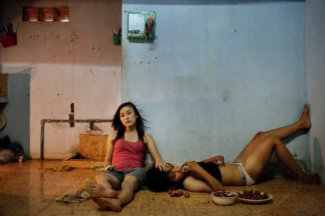 This picture by Vietnamese photographer Maika Elan commissioned by Moss won the 1st prize stories for [The Pink Choice] in the category [Contemporary Issues] with in the 56th World Press Photo Contest, it was announced by the organizers on 15 February 2013 in Amsterdam, The Netherlands. Phan Thi Thuy Vy and Dang Thi Bich Bay, who have been together for one year, watch television to relax after studying at school. Vietnam has historically been unwelcoming to same-sex relationships. But its Communist government is considering recognizing same-sex marriage, a move that would make it the first Asian country to do so, despite past human rights issues and a long-standing stigma. In August 2012, the country's first public gay pride parade took place in Hanoi. This photograph is dated 22 June 2012 in Da Nang, Vietnam. (Photo by Maika Elan/EPA)