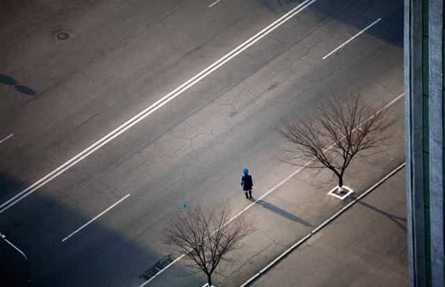 In this April 13, 2011 photo, a North Korean traffic police officer stands along a street in central Pyongyang, North Korea. (Photo by David Guttenfelder/AP Photo)