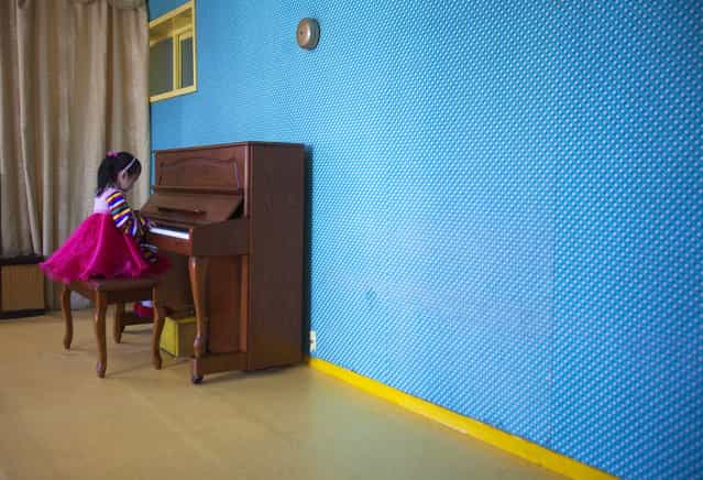 In this March 9, 2011 photo, a girl plays the piano inside the Changgwang Elementary School in Pyongyang, North Korea. (Photo by David Guttenfelder/AP Photo)