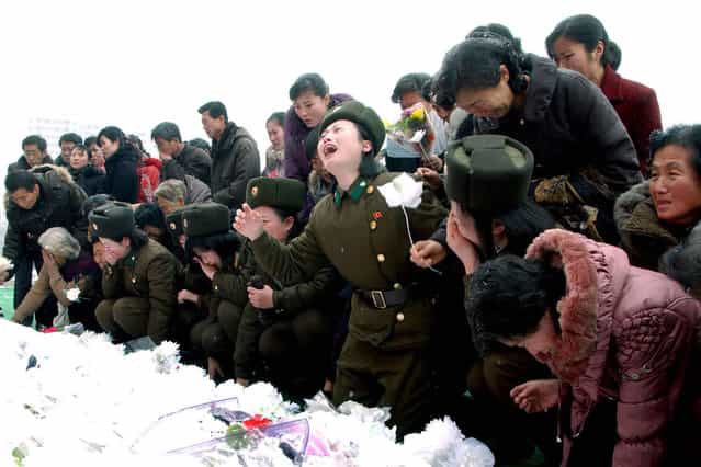 North Koreans react as they make a call of condolence for deceased leader Kim Jong Il in Pyongyang, on December 21, 2011. (Photo by Reuters/KCNA)
