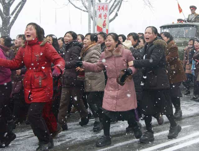 Mourners cry during the funeral procession for late North Korean leader Kim Jong Il, in Pyongyang, North Korea Wednesday, December 28, 2011. (Photo by AP Photo/Kyodo News)