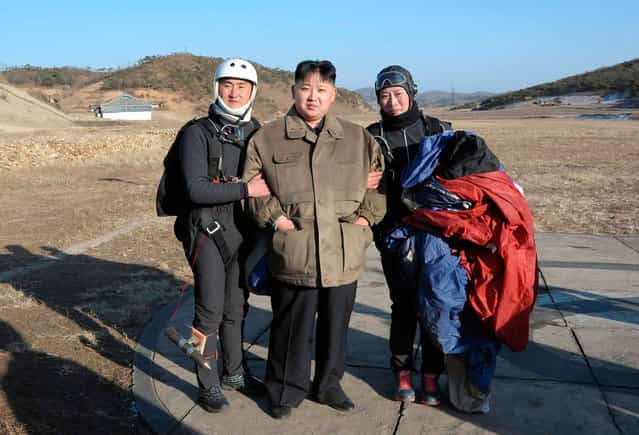The leader of North Korea, Kim Jong Un, poses with members of the Western Area Aviation Club after watching a demonstration by them in an undisclosed location in this undated picture released on January 28, 2012. (Photo by Reuters/KCNA)