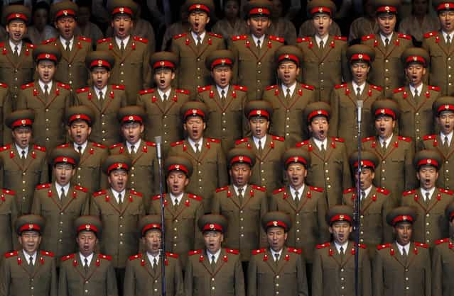 In this April 16, 2012 photo, North Korean soldiers sing at the Pyongyang indoor gymnasium to commemorate late president Kim Il Sung's 100th birthday in Pyongyang, North Korea. (Photo by Vincent Yu/AP Photo)