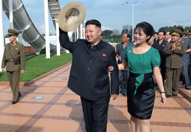 In this July 25, 2012 file photo released by the Korean Central News Agency (KCNA) and distributed in Tokyo by the Korea News Service, North Korean leader Kim Jong Un, accompanied by his wife Ri Sol Ju, waves to the crowd as they inspect the Rungna People's Pleasure Ground in Pyongyang. (Photo by AP Photo/Korean Central News Agency via Korea News Service)