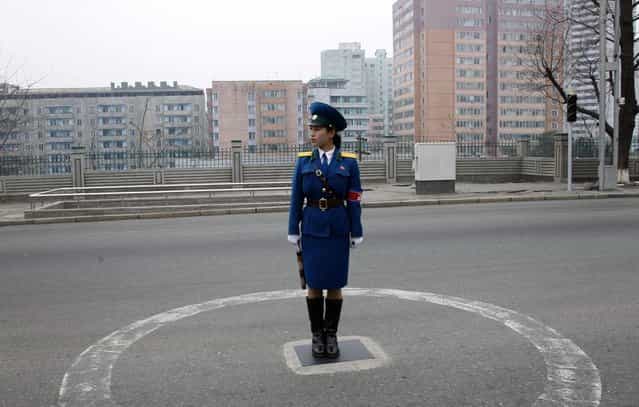 A North Korean traffic coordinator stands on duty in Pyongyang, on April 10, 2012. (Photo by Ng Han Guan/AP Photo)