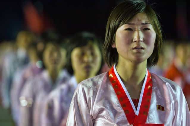 A North Korean woman weeps while singing a song about North Korean leader Kim Jong Un at the end of a mass dance performance in Kim Il Sung Square in Pyongyang, on April 16, 2012. (Photo by David Guttenfelder/AP Photo)