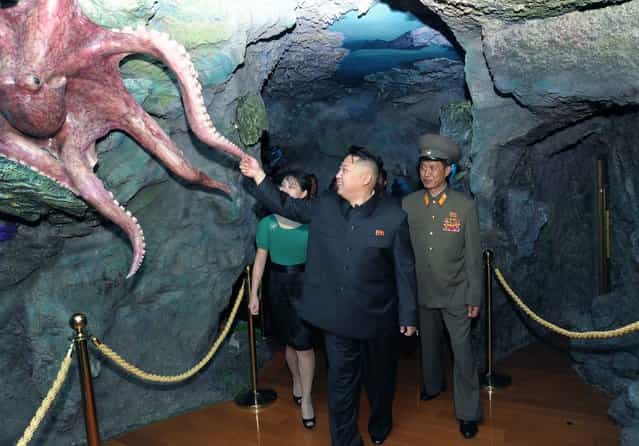 North Korean leader Kim Jong-Un (C) and his wife Ri Sol-Ju attend the opening ceremony of the Rungna People's Pleasure Ground on Rungna Islet along the Taedong River in Pyongyang in this July 25, 2012 photograph released by the North's KCNA to Reuters on July 26, 2012.The Rungna People's Pleasure Ground has attractions such as a dolphinarium, a wading pool, a fun fair and a mini golf course, according to KCNA. (Photo by Reuters/KCNA)