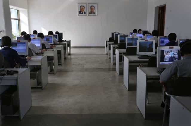 North Korean students study in front of portraits of the country's late leaders Kim Il Sung, left, and his son Kim Jong Il at the Kim Chaek University of Technology in Pyongyang, on September 20, 2012. (Photo by Vincent Yu/AP Photo)