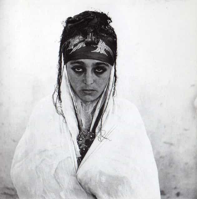 A 1960 photograph of an Algerian woman in a French regroupment village. (Photo by Marc Garanger)