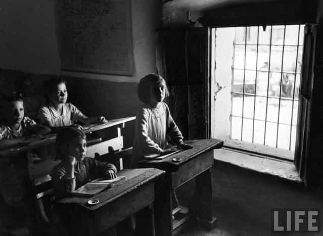 Girls are taught in separate classes from the boys. Four rooms and four lay teachers handle all pupils, as many as 300 in winter, between the ages of 6 and 14. (Photo by W. Eugene Smith/Time & Life Pictures)