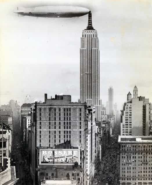 [Dirigible Docked on Empire State Building, New York] by Unknown, American, 1930. In 1930 International News Photos transmitted over the wires this photograph of the U.S. Navy dirigible Los Angeles docked at a mooring mast atop the Empire State Building. In fact, no airship ever docked there, and the notion of the mast itself was a publicity stunt perpetrated by the building’s backers. In late 1929 Alfred E. Smith, the leader of a group of investors erecting the Empire State Building, announced that they would be increasing the building’s height by two hundred feet, making it slightly taller than its rival, the Chrysler Building. The tower’s extension was to serve as a mooring mast for zeppelins from which weary European travelers would be able to disembark via a gangplank into a private elevator that would whisk them to street level in just seven minutes. Ultimately, the unceasing gusty winds at the tower’s pinnacle made the plan impossible to execute, but the mast remained, allowing the Empire State Building to claim the title of world’s tallest skyscraper. (Photo courtesy of The Metropolitan Museum of Art)