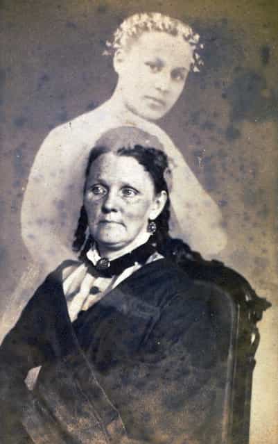 [Unidentified Woman Seated with a Female Spirit] by William Mumler, 1862-75. In the early 1860s Mumler became the first producer and marketer of [spirit photographs], portraits in which hazy figures, presumed to be the spirits of the deceased, loom behind or alongside living sitters. He quickly garnered the support of the burgeoning Spiritualist movement, which held that the human spirit exists beyond the body and that the dead can – and do – communicate with the living. Mumler first discovered his calling while working as a jewelry engraver in Boston, but his career there was cut short when a ghost that had appeared in two of his photographs was discovered to be a local resident who was still very much alive. In 1868 he opened a studio in New York City but was arrested the following year on charges of fraud and larceny. (Photo courtesy of The Metropolitan Museum of Art)