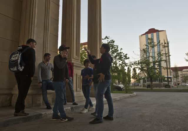 A group of young Chechen men hang out on a street corner in the centre of the Chechen capital Grozny April 29, 2013. (Photo by Maxim Shemetov/Reuters)