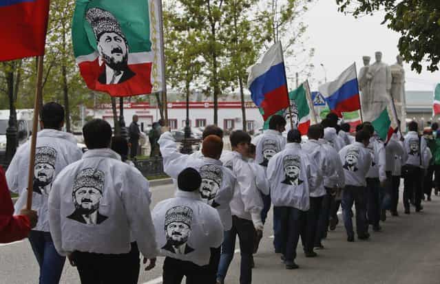 Members of a youth club supporting former Chechen leader Akhmad Kadyrov march along the street during a rally in the centre of the Chechen capital Grozny April 25, 2013. (Photo by Maxim Shemetov/Reuters)