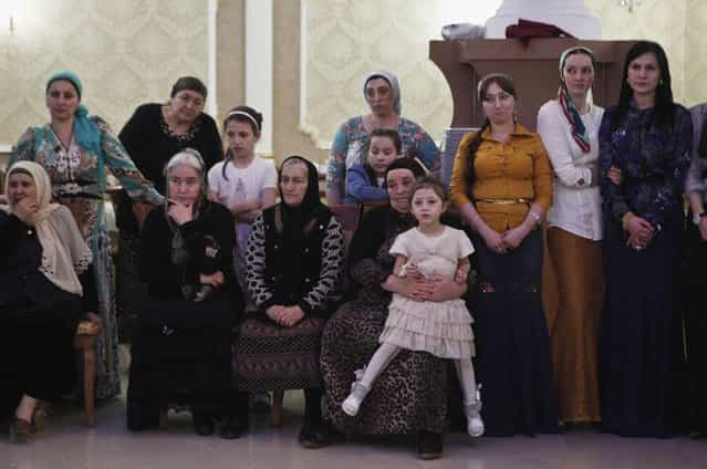 Women watch dancing at a wedding party in the Chechen capital Grozny April 24, 2013