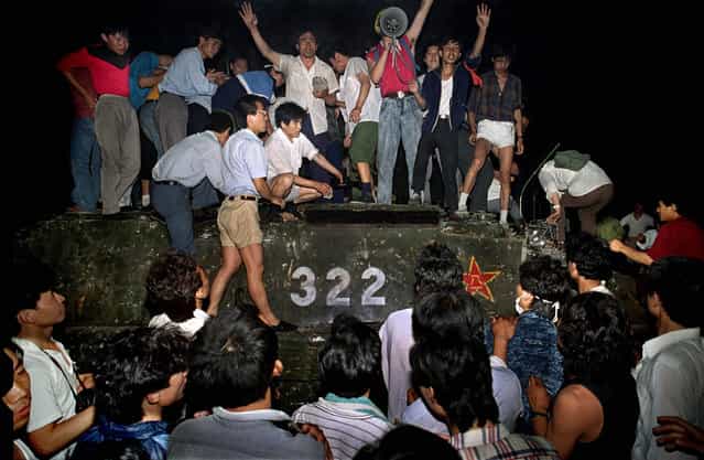 Chinese student protestors swarm over a captured PLA tank, Tiananmen Square Protests, Beijing, China, 1989. (Photo by Jeff Widener/Associated Press)