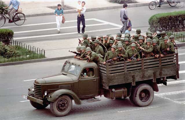 A truck drives Chinese soldiers down Chang'an Boulevard in Beijing, on June 5, 1989, one day after violence between government troops and pro-democracy protesters left hundreds dead. (Photo by Jeff Widener/AP Photo)