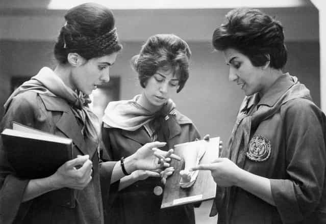 Picture taken in 1962 at the Faculty of Medicine in Kabul of two Afghan medicine students listening to their professor (at right) as they examine a plaster cast showing a part of a human body. (Photo by AFP/Getty Images via The Atlantic)