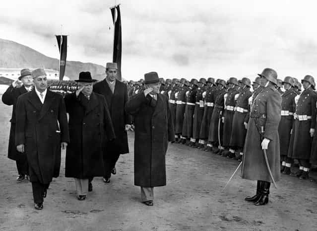Soviet leader Nikita Khrushchev (black hat), and Marshal Nikolai Bulganin review an Afghan honor guard wearing old German uniforms, on their arrival in Kabul, Afghanistan, on December 15, 1955. At left is the Afghan Prime Minister Sardar Mohammed Daud Khan, and behind, in cap, the foreign minister, Prince Naim. (Photo by AP Photo via The Atlantic)