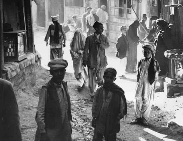Afghan boys, men, and a woman walk through a street in Kabul, Afghanistan, on March 26, 1954. (Photo by AP Photo via The Atlantic)