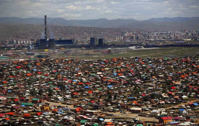 An area known as a ger district is seen in Ulan Bator June 28, 2013. Approximately 60 percent of the population of Ulan Bator live in settlements known as ger districts and in many cases residents have limited access to basic services such as water and sanitation. According to a 2010 National Population Center census, every year between thirty and forty thousand people migrate from the countryside to the capital Ulan Bator. Ger districts in the city have been expanding rapidly in recent years. Mongolia is the world's least densely populated country, with 2.8 million people spread across an area around three times the size of France. (Photo by Carlos Barria/Reuters)