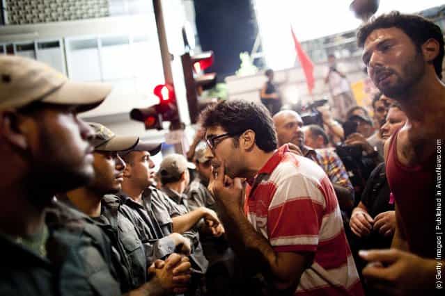 Israeli police officers confront demonstrator as Israelis protest against rising housing prices and social inequalities on July 30, 2011 in Tel Aviv, Israel