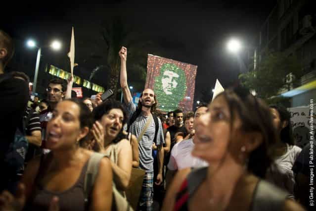 Israelis march as they protest against rising housing prices and social inequalities on July 30, 2011 in Tel Aviv, Israel