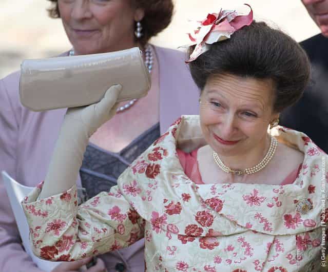 Princess Anne, Princess Royal waves off Zara Philips as she eaves Canongate Kirk on the afternoon of her wedding to Mike Tindall on July 30, 2011 in Edinburgh, Scotland