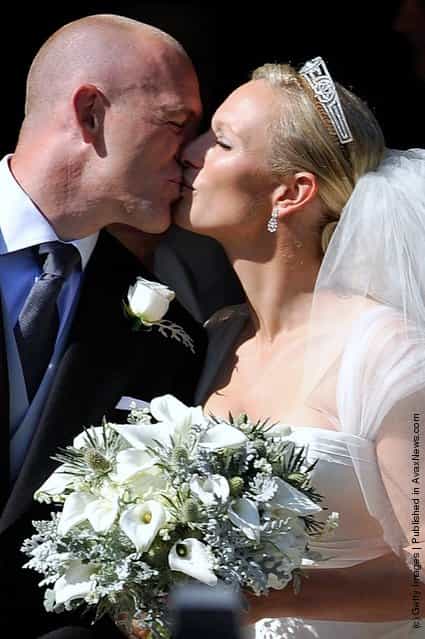 England rugby captain Mike Tindall and Zara Phillips kiss as they leave the church after their marriage