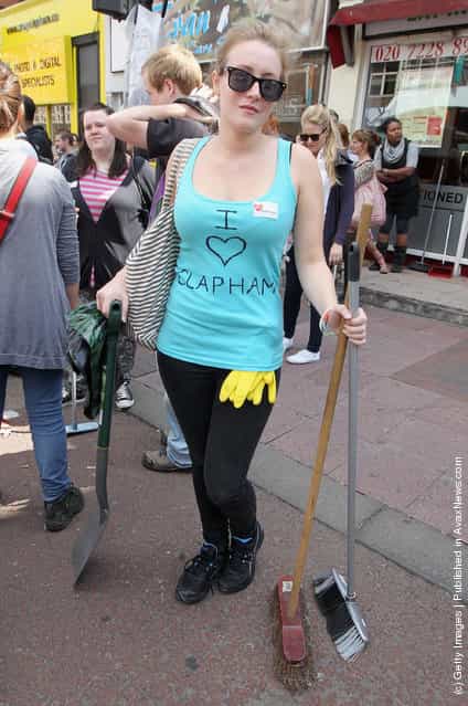 Volunteers get ready to clean up after last nights rioting at Clapham Junction on August 9, 2011 in London, England