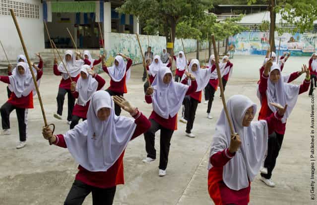Islamic female students practice the ancient Thai art of Krabi Krabong taught as a sport at the Darunsat Wittaya school