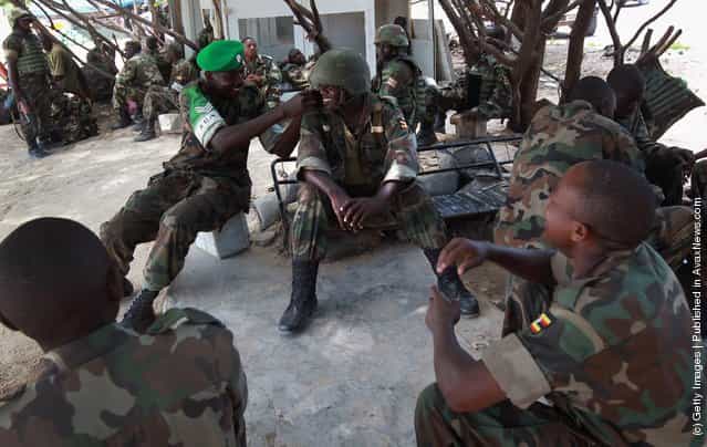 Ugandan soldiers prepare to go on patrol