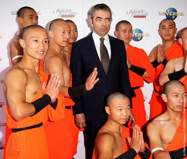 Rowan Atkinson poses with Shaolin Monks, Johnny English Reborn World Premiere