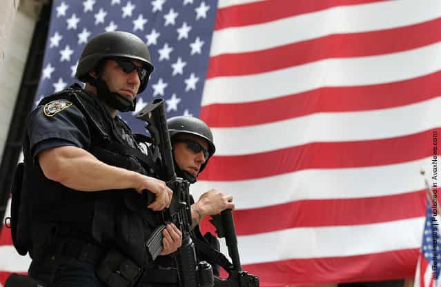 New York Police Department tactical police officers stand guard near the New York Stock Exchange