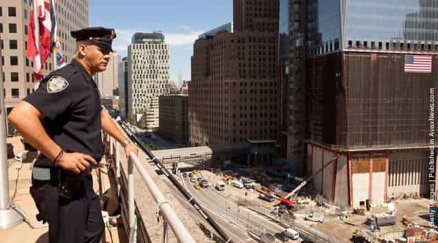 A Police officer looks over teh World Trade Center site from the tenth floor balcony of Two World Trade Center