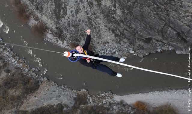 Chris Ashton, the England wing, is hoisted back up after his bungy jump at the 134 meter high Nevis Bungy jump during an England IRB Rugby World Cup 2011 team visit