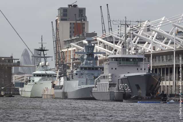 Naval vessels are moored alongside the ExCeL exhibition centre