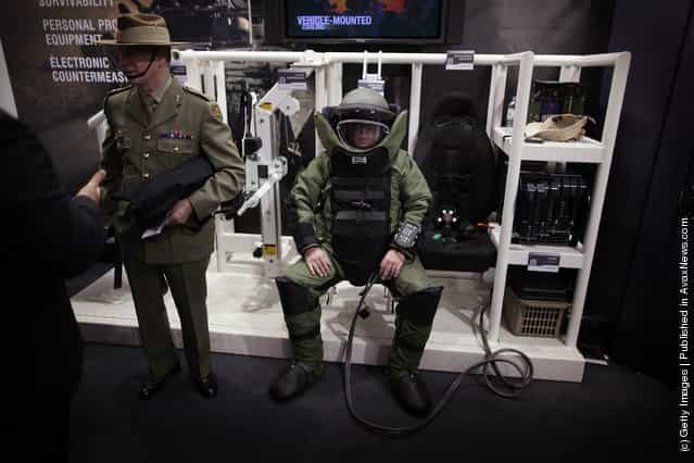 A soldier sits in an air cooled bomb disposal uniform at the Defence and Security Exhibition