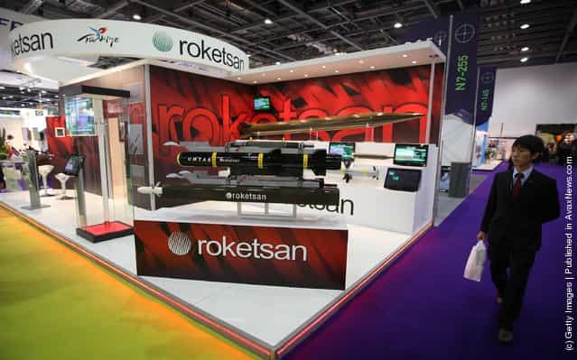 A visitor walks past the Turkish missile manufacturer Roketsans stand at the Defence and Security Exhibition