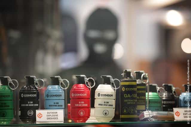 Gas cannisters and explosive grenades are displayed at the Defence and Security Exhibition