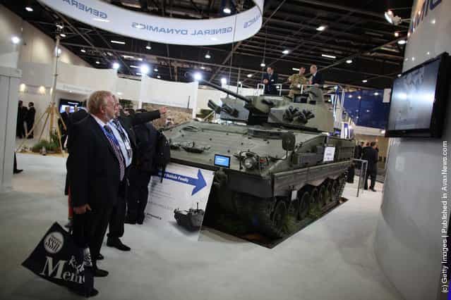 Visitors look at a General Dynamics Scout Special Vehicle on display at the Defence and Security Exhibition