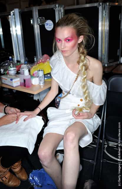 A model prepares backstage before the Vivienne Westwood show during London Fashion Week Spring/Summer 2012